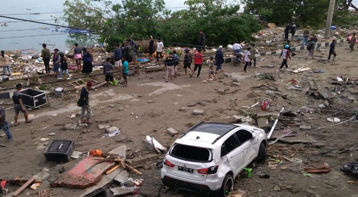 Aid rolls into stricken city of Indonesia as death toll climbs